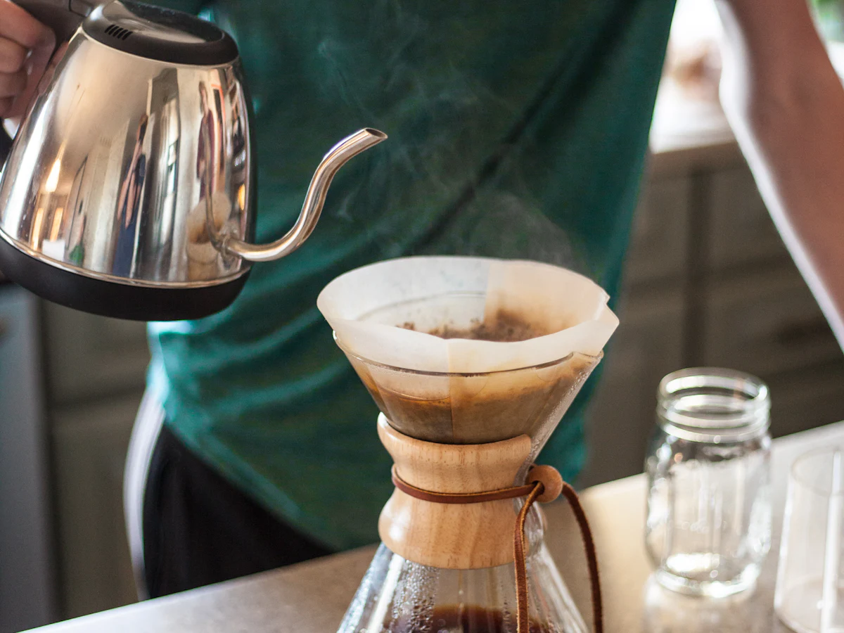 Water poured from a kettle into a pour-over brewer